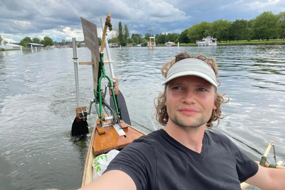 Ben paddling on his DIY timber canoe